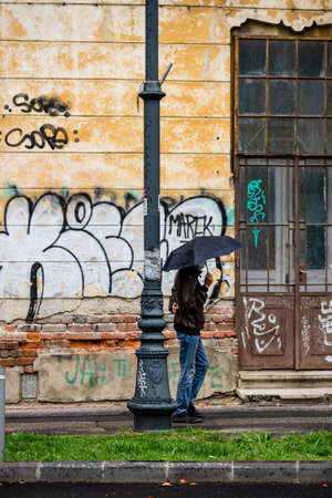 People with umbrella on the street on a rainy day in Bucharest, Romania, 2021のeditorial素材