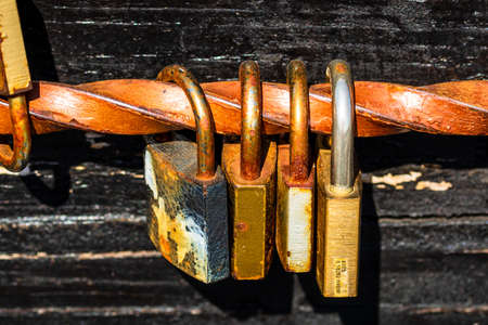 Love symbol, old rusty padlocks hanging on wooden fortress bridge in Alba Iulia, Romania, 2021のeditorial素材
