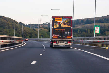 Loaded European truck in motion on asphalt road, transportation and delivery concept. Bucharest, Romania, 2020のeditorial素材