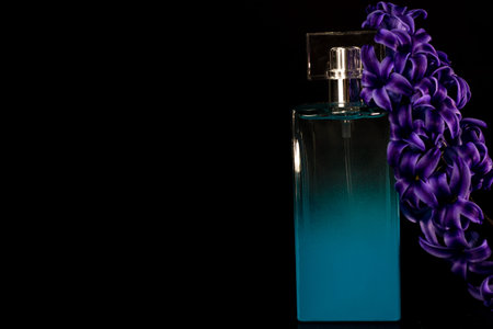 Elegant perfume bottle isolated on black background with copy space.