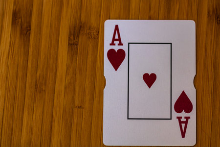 Detail of Ace of hearts card on wooden tableの写真素材