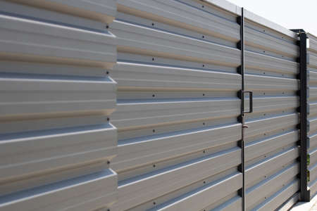 Close up of corrugated metal fence,  horizontal modern metal fenceの写真素材
