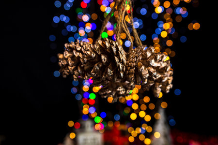 Holding Christmas decoration against bokeh lights backgroundの写真素材