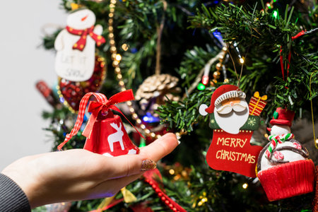 Hanging Christmas decorations and ornaments in the Christmas tree