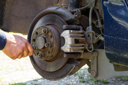 Mechanic cleaning and fixing the brake system of a car in Romania, Targoviste, 2021のeditorial素材