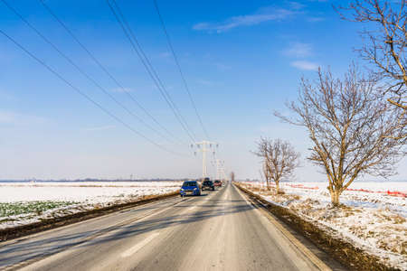 Winter season, view of cars and snowy street through windshield while driving in Bucharest, Romania, 2021.のeditorial素材