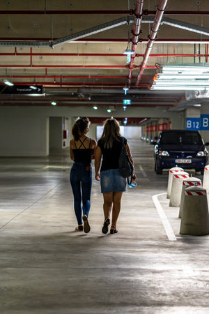 Women walking alone in underground parking garage in Bucharest, Romania, 2021のeditorial素材