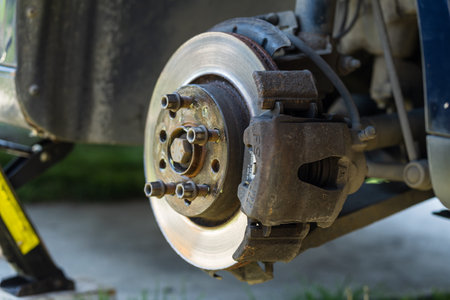 Mechanic cleaning and fixing the brake system of a car in Romania, Targoviste, 2021