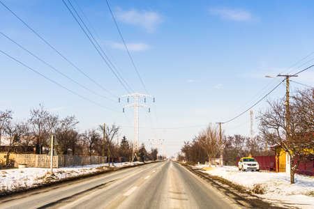 Winter season, view of cars and snowy street through windshield while driving in Bucharest, Romania, 2021.のeditorial素材