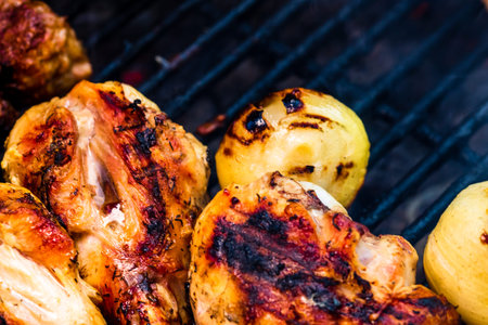 Chicken steak grilled and meat rolls on a charcoal barbeque. Top view of camping tasty barbecue,...