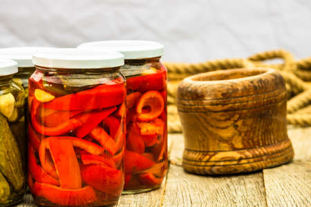 Glass jars with pickled red bell peppers. Preserved food concept, canned vegetablesの写真素材