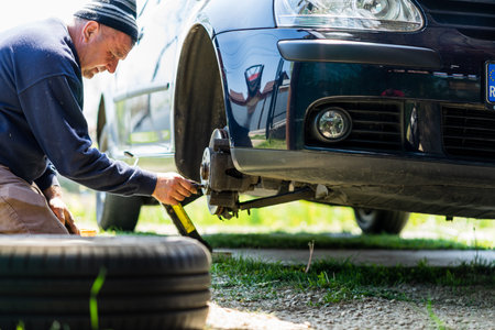 Mechanic cleaning and fixing the brake system of a car in Romania, Targoviste, 2021
