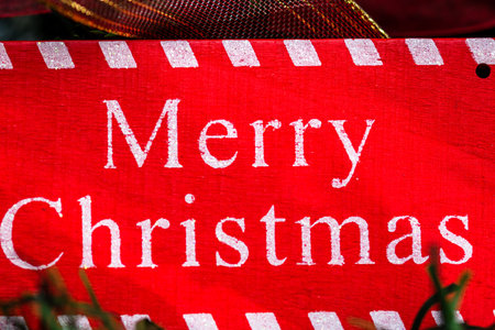 Merry Christmas sign hanging in the Christmas tree