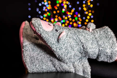 Legs in winter Christmas socks on blurred lightsの写真素材