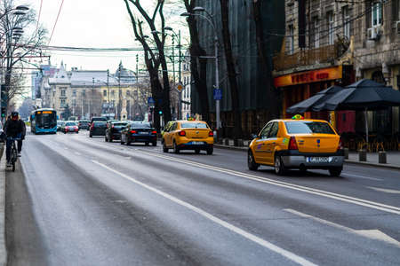 Cars in traffic at rush hour in downtown area of the city. Car pollution, traffic jam in the morning and evening in the capital city of Bucharest, Romania, 2021のeditorial素材