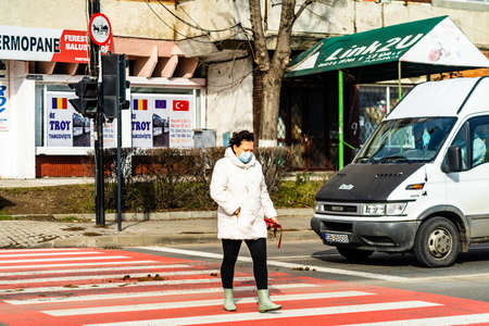 Pedestrian crossing the streed using the zebra crossing in Bucharest, Romania, 2021のeditorial素材