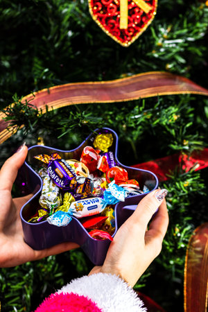 Sweets under Christmas tree. Christmas decorations concept in Bucharest ,Romania, 2022