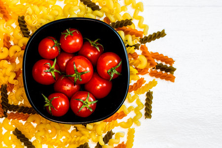Beautiful tasty Italian pasta, tomatoes, onions and garlic for cooking pastaの写真素材