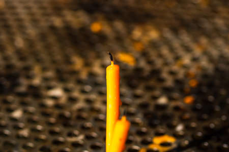 Burning melting candles in memory of the dead, close up.の写真素材