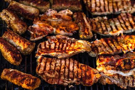 Grilling  pork chops on barbecue grill. BBQ in the gardenの写真素材