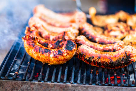 Grilling sausages and pork chops on barbecue grill. BBQ in the gardenの写真素材