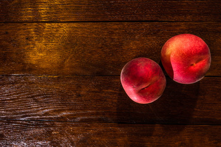 Fresh juicy peaches on rustic wooden table