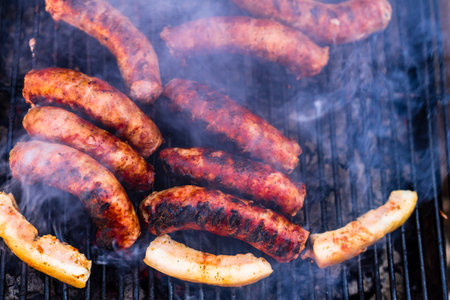 Grilling sausages and pork chops on barbecue grill. BBQ in the gardenの写真素材