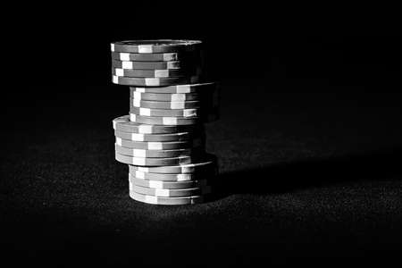Stack of poker chips on black backgroundの写真素材