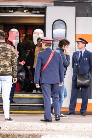 Travelers and commuters waiting for a train on the train platform of Bucharest North Railway Station...
