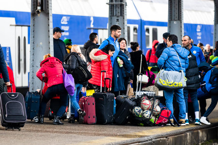 Travelers and commuters waiting for a train on the train platform of Bucharest North Railway Station...
