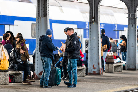 Travelers and commuters waiting for a train on the train platform of Bucharest North Railway Station...