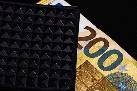 200 Euro banknotes in a black wallet isolated.の写真素材
