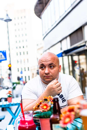 Young man at restaurant table in Bucharest, Romania, 2022のeditorial素材