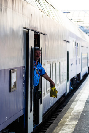 Railworker, train staff signaling for train conductor in Bucharest, Romania, 2022