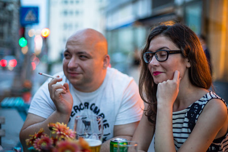 Young couple at restaurant table socializing in Bucharest, Romania, 2022