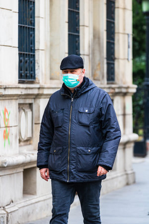 People on the street wearing masks in Bucharest, Romania, 2022