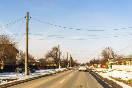 Winter season, view of cars and snowy street through windshield while driving in Bucharest, Romania,...