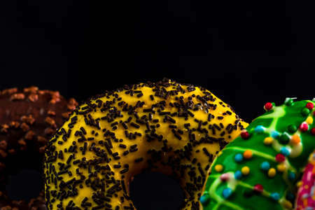 Glazed donuts with sprinkles isolated. Close up of colorful donuts.の写真素材