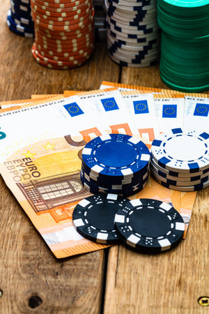 Poker casino chips and money close up. Casino concept, risk, chance, good luck or gambling. Detail...