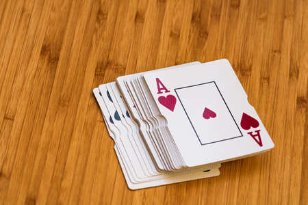 Playing cards close up, isolated on wooden table. Casino concept, risk, chance, good luck or gambling.の写真素材