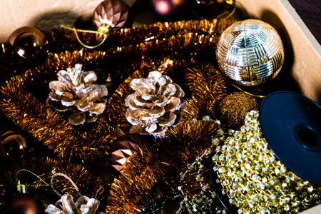 Christmas decorations in a box. Christmas concept. Christmas balls, pine cones, garlands.