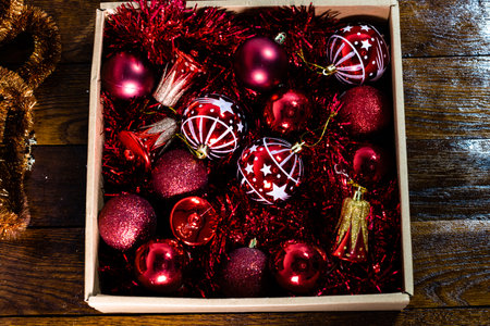 Christmas decorations in a box. Christmas concept. Box with red Christmas balls and garlands.の写真素材