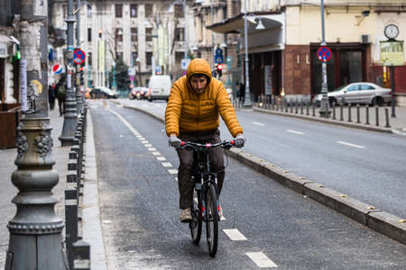 Riding a bicycle on the city streets. Commute to work in Bucharest, Romania, 2022のeditorial素材