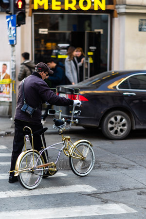 Riding a bicycle on the city streets. Commute to work in Bucharest, Romania, 2022