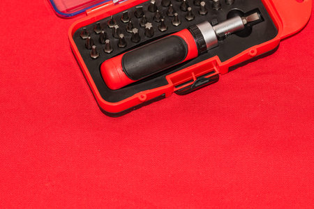 Close up of interchangeable screwdriver set with different types of metal steel heads and bits.