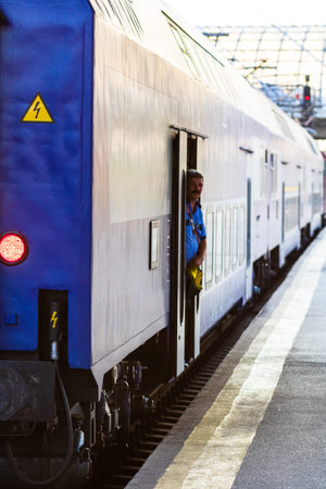 Railworker, train staff signaling for train conductor in Bucharest, Romania, 2022