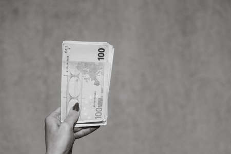 Hand holding and showing euro money or giving money. World money concept, 100 EURO banknotes EUR currency isolated. Concept of rich business people, saving or spending money.の写真素材
