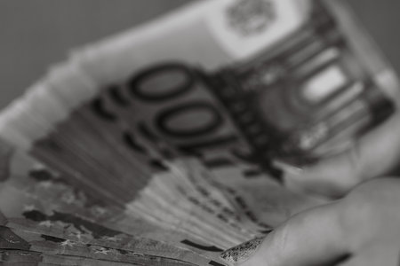 Selective focus on detail of EURO banknotes. Counting or giving EURO banknotes. World money concept, inflation and economy conceptの写真素材