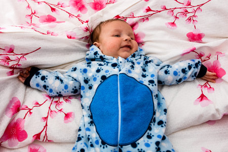 Sleeping newborn baby boy in bed. Newborn baby