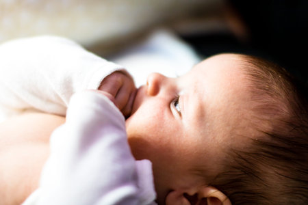 Sleeping newborn baby boy in bed. Newborn baby